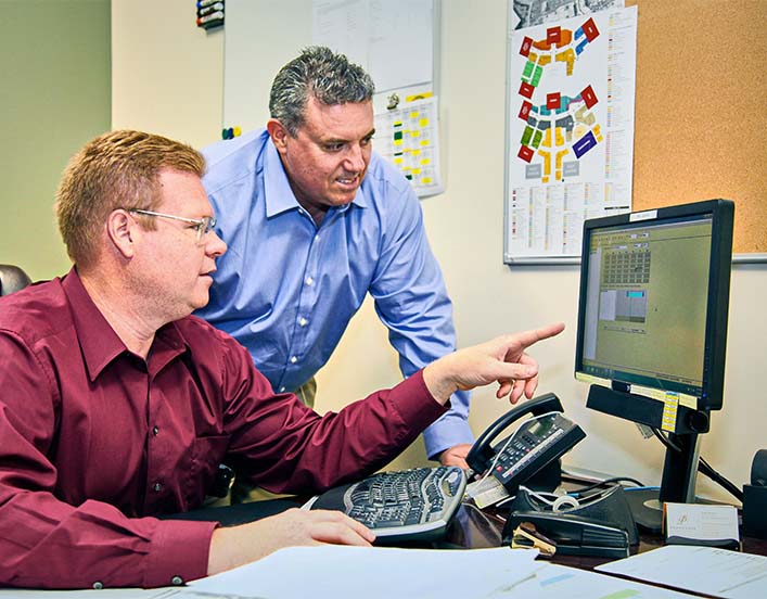 Two men looking at computer screen