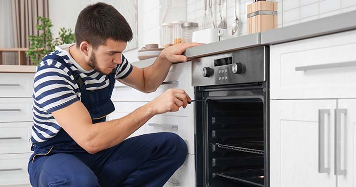 man installing oven 