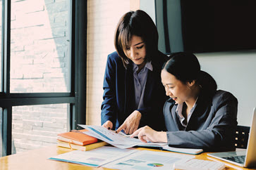 adobe stock image two women discussing bills